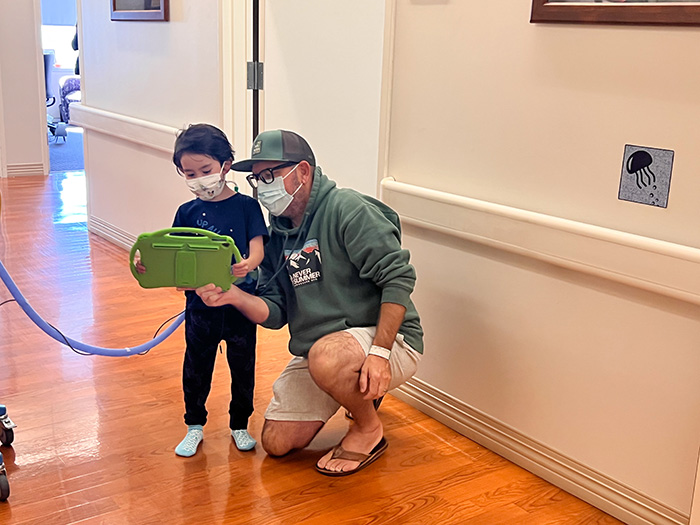 CHOC patient Kai using the module with his dad at CHOC at Mission Hospital